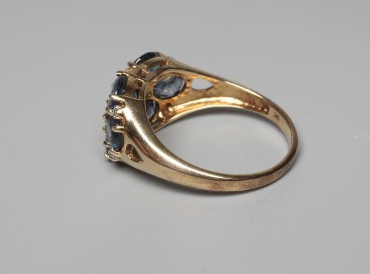A SAPPHIRE DRESS RING, the seven stones claw set with diamond points between to open shoulders and a Image