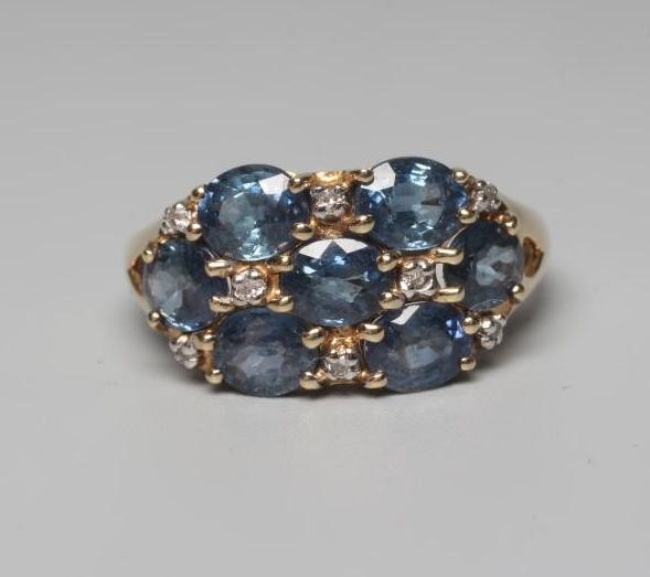 A SAPPHIRE DRESS RING, the seven stones claw set with diamond points between to open shoulders and a Image