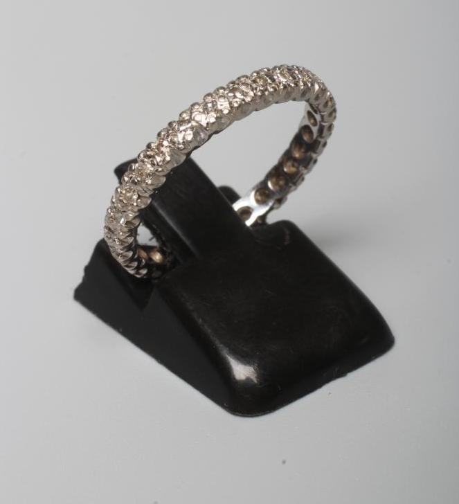 A DIAMOND ETERNITY RING pave set with numerous old cut small stones to an unmarked bead stamped Image
