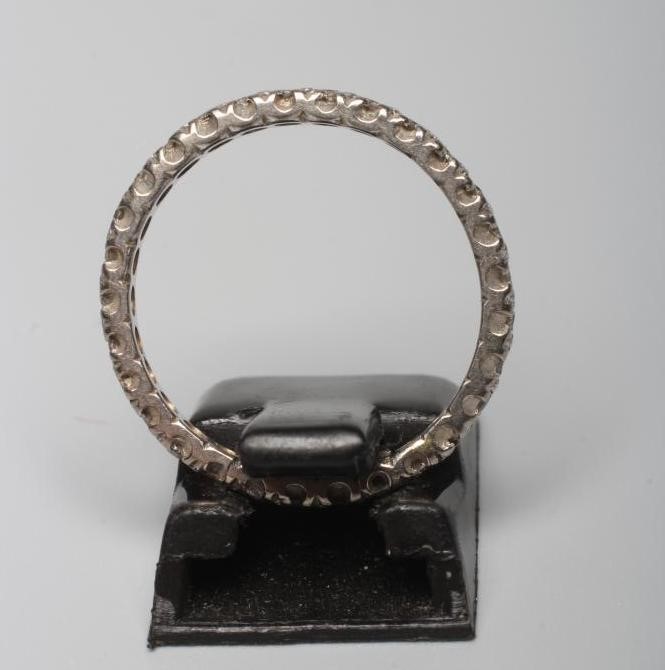 A DIAMOND ETERNITY RING pave set with numerous old cut small stones to an unmarked bead stamped Image
