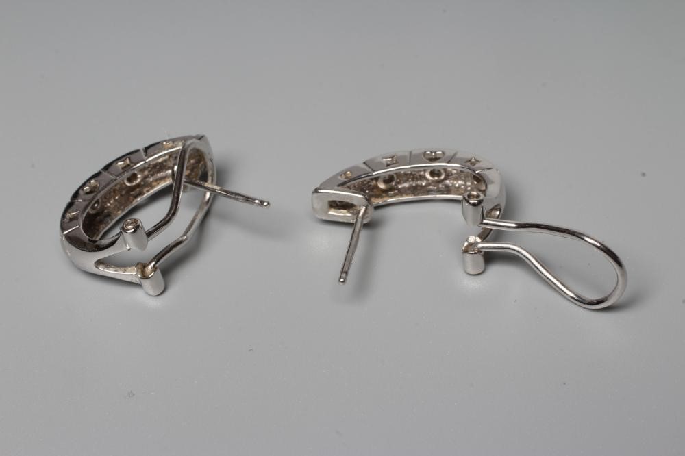 A PAIR OF DIAMOND EARRINGS, the matt and polished hexagonal engraved half loops each inset with Image