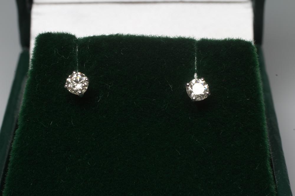 A PAIR OF DIAMOND SOLITAIRE EAR STUDS, each brilliant cut stone of 0.28cts, claw set to unmarked Image