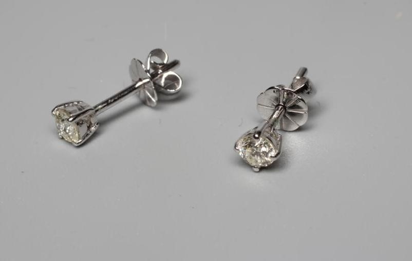 A PAIR OF DIAMOND SOLITAIRE EAR STUDS, each brilliant cut stone of 0.28cts, claw set to unmarked Image