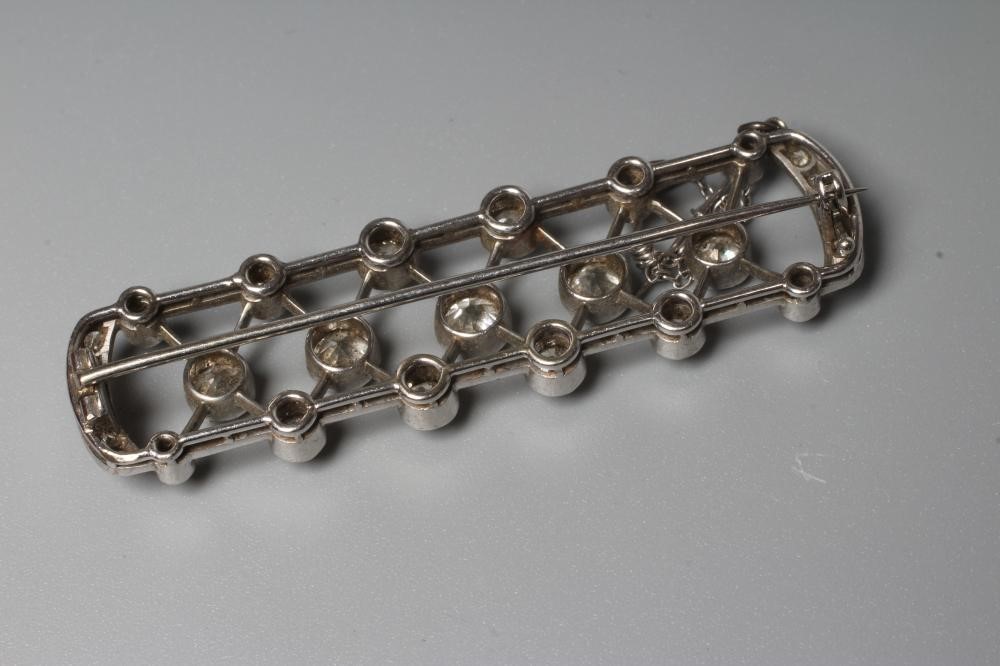 AN ART DECO DIAMOND BROOCH of D end oblong form centred by a lattice with seventeen diamonds collet Image