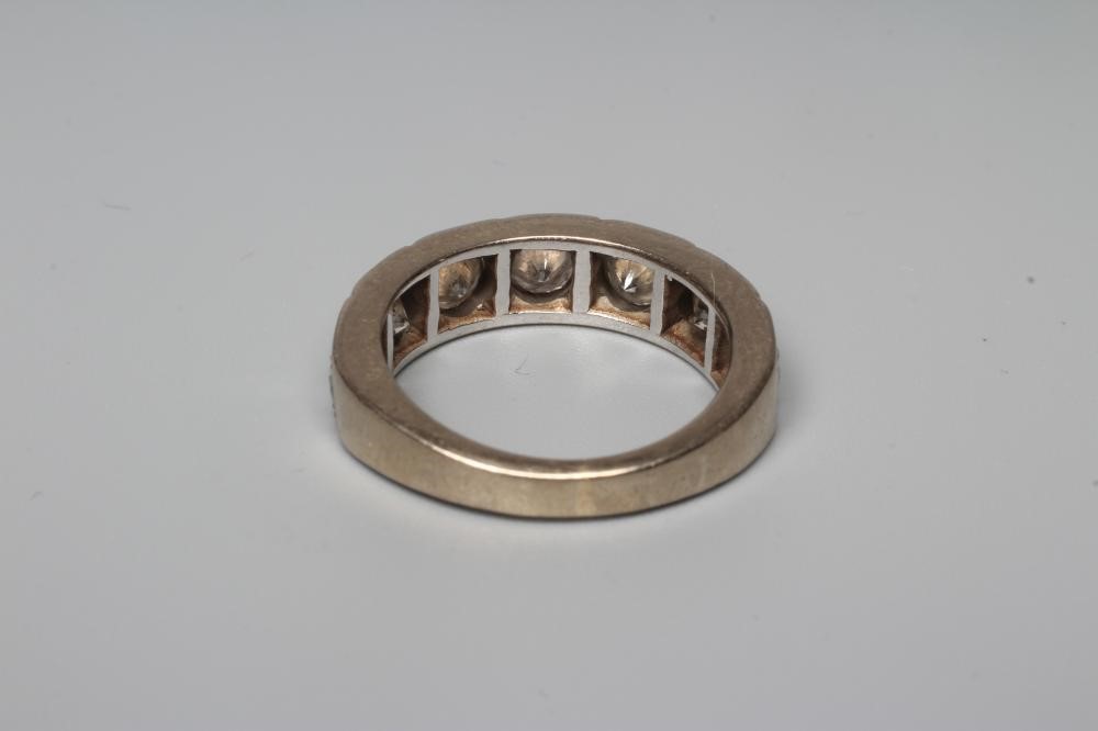 A SEVEN STONE DIAMOND HALF HOOP RING Image