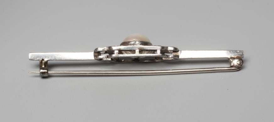 AN ART DECO PEARL AND DIAMOND BAR BROOCH, the central bouton in rub over setting with three small Image