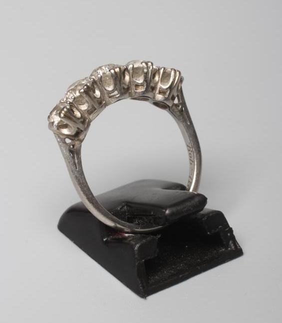 A FIVE STONE DIAMOND RING, the central brilliant cut stone of approximately 0.5cts flanked by four Image