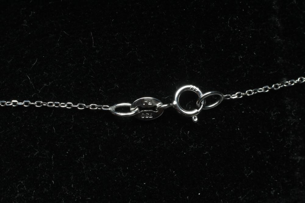 A SAPPHIRE AND DIAMOND CLUSTER PENDANT, the pear cut sapphire claw set to a border of round Image