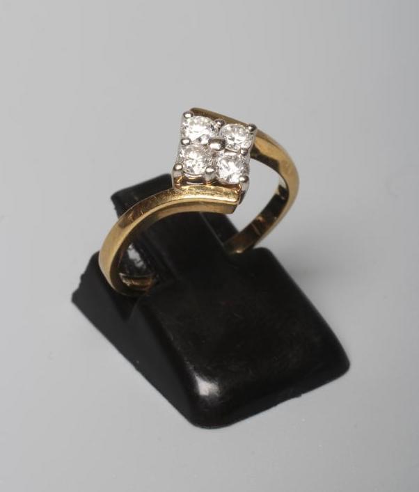 A FOUR STONE DIAMOND RING, the round brilliants each of approximately 0.10cts, claw set to a Image