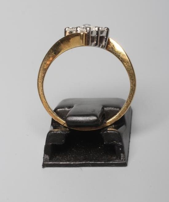 A FOUR STONE DIAMOND RING, the round brilliants each of approximately 0.10cts, claw set to a Image