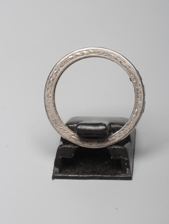 A RUBY ETERNITY RING, the calibre cut stones channel set to a foliate engraved platinum shank, Image
