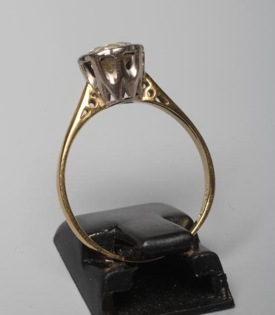 A SOLITAIRE DIAMOND RING, the brilliant cut stone of 1.03cts illusion set to a plain 18ct gold Image