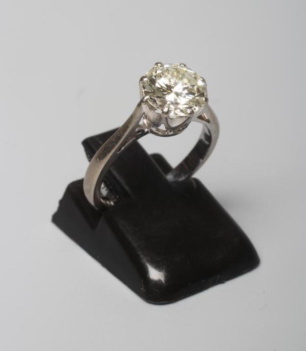 A SOLITAIRE DIAMOND RING, the round brilliant cut stone of approximately 1.4cts, claw set to a plain Image