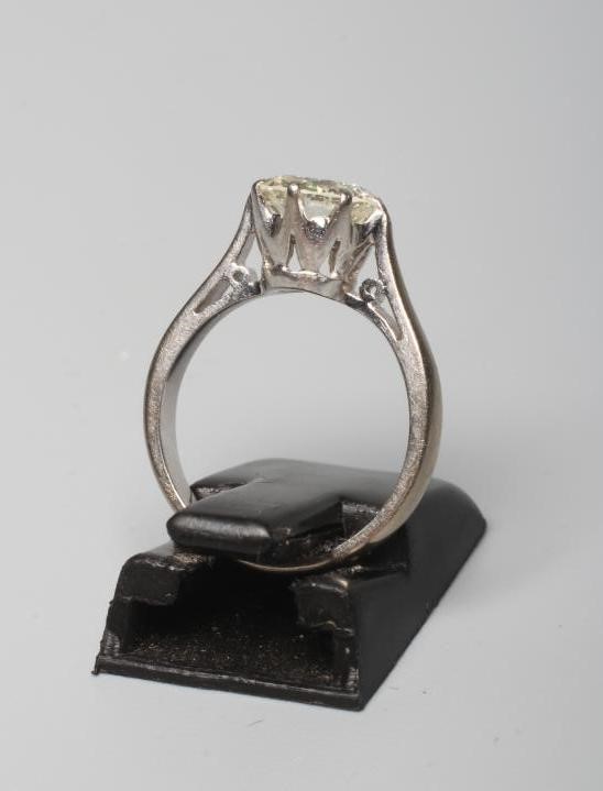 A SOLITAIRE DIAMOND RING, the round brilliant cut stone of approximately 1.4cts, claw set to a plain Image