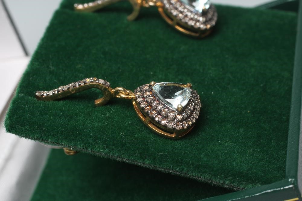 A PAIR OF AQUAMARINE AND DIAMOND DROP EAR STUDS, the facet cut triangular aquamarines claw set to a Image