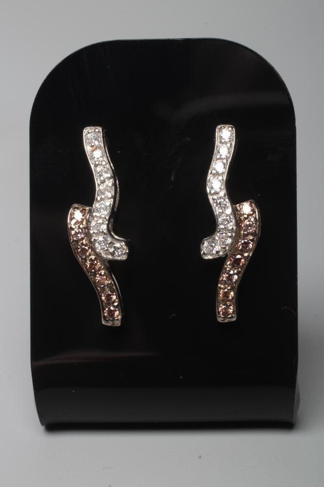 A PAIR OF BROWN AND WHITE DIAMOND EAR STUDS Image