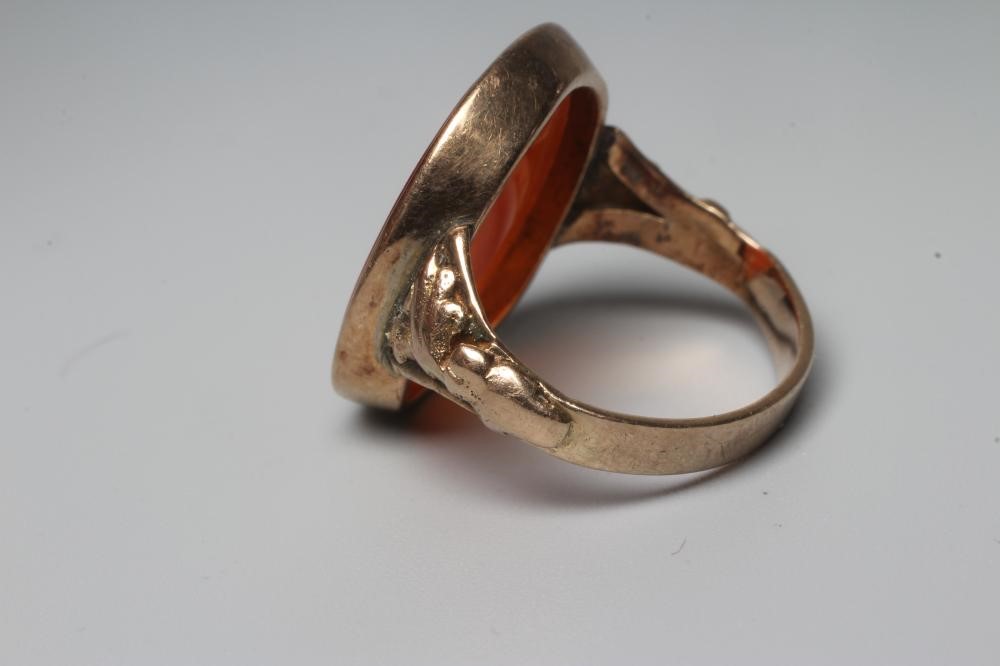 A LATE 18TH CENTURY SEAL RING, the oval cornelian incuse carved with a male head portrait, in a rub Image