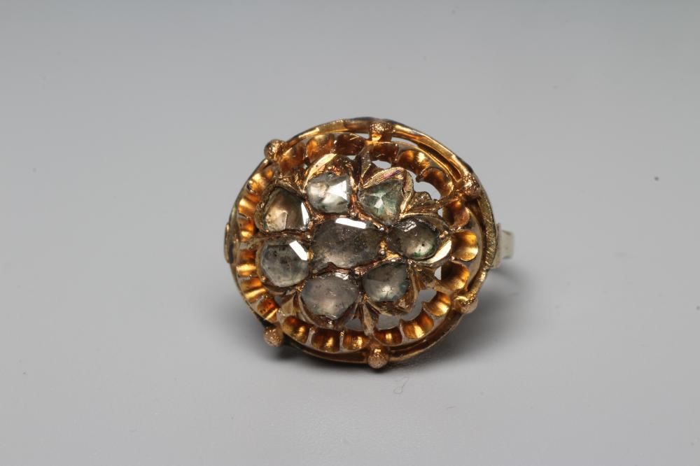 A DIAMOND DRESS RING, centrally set with eight mixed rose cut stones to an open frame and plain Image