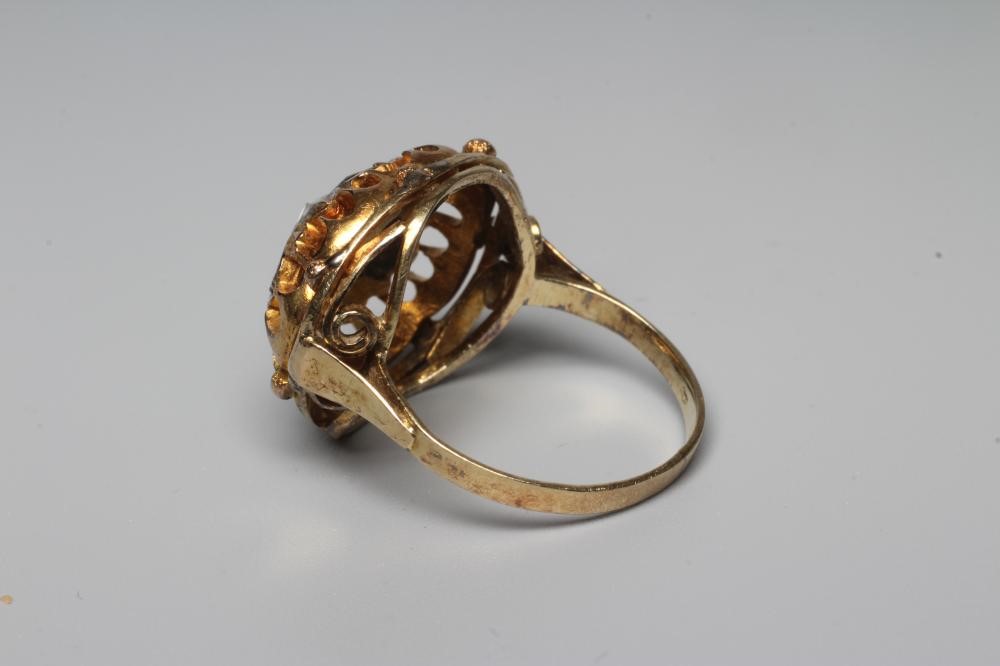 A DIAMOND DRESS RING, centrally set with eight mixed rose cut stones to an open frame and plain Image