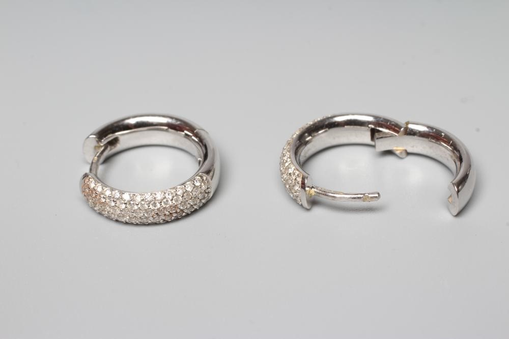 A PAIR OF DIAMOND EAR HOOPS pave set with numerous small brilliant cut stones to plain 18ct white Image