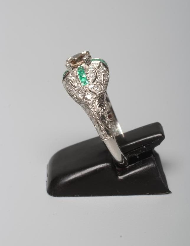 AN ART DECO STYLE DIAMOND AND EMERALD DRESS RING Image