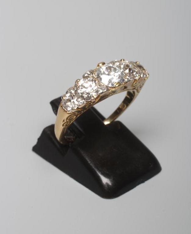 A FIVE STONE DIAMOND RING, the central brilliant cut stone of approximately 0.7cts claw set and Image