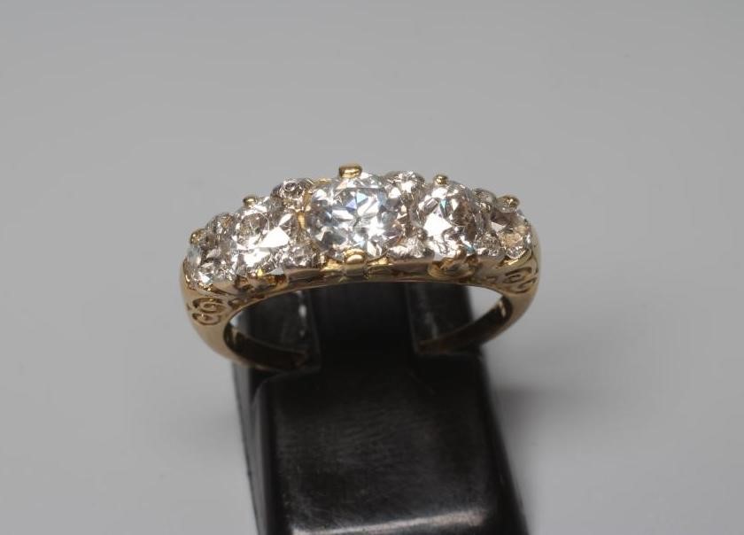 A FIVE STONE DIAMOND RING, the central brilliant cut stone of approximately 0.7cts claw set and Image