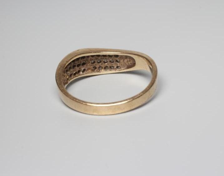 A DIAMOND DRESS RING, the wavy band point set with three bands of eleven stones to a plain shank Image