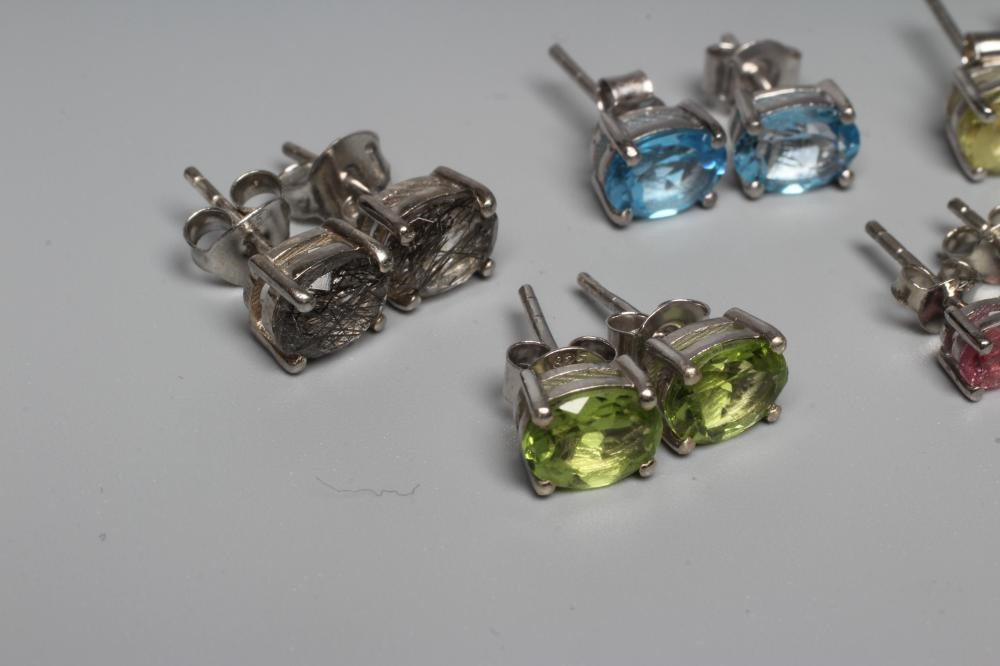 FIVE PAIRS OF GEM SET EAR STUDS including pink tourmaline, blue topaz and peridot, all set in silver Image