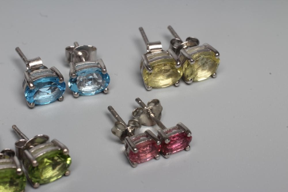 FIVE PAIRS OF GEM SET EAR STUDS including pink tourmaline, blue topaz and peridot, all set in silver Image