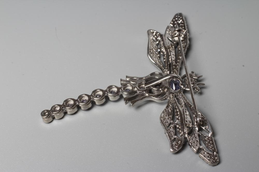 A TANZANITE AND DIAMOND DRAGONFLY BROOCH, the body and head set with graduating oval cut tanzanite Image