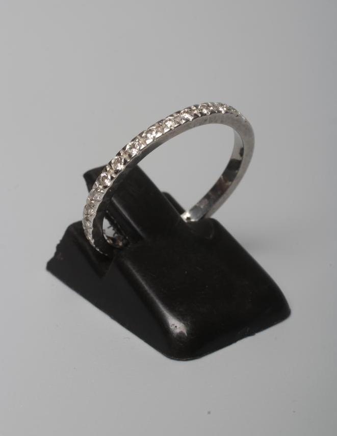 A DIAMOND HALF HOOP ETERNITY RING, the twenty two small round brilliants pave set to a plain white Image
