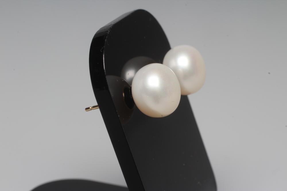 A PAIR OF CULTURED PEARL EAR STUDS, the peg set pearls on plain posts stamped 375 with butterflies Image