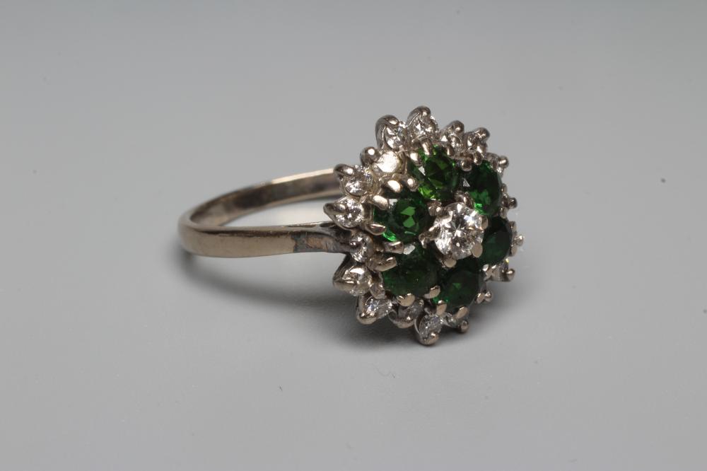 A GREEN TOURMALINE AND DIAMOND CLUSTER COCKTAIL RING, the stones claw set to a plain 18ct white gold Image