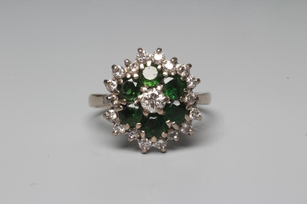 A GREEN TOURMALINE AND DIAMOND CLUSTER COCKTAIL RING, the stones claw set to a plain 18ct white gold Image