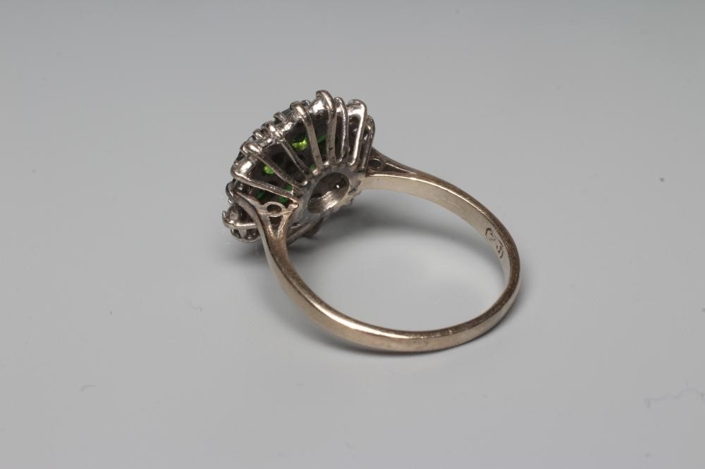 A GREEN TOURMALINE AND DIAMOND CLUSTER COCKTAIL RING, the stones claw set to a plain 18ct white gold Image