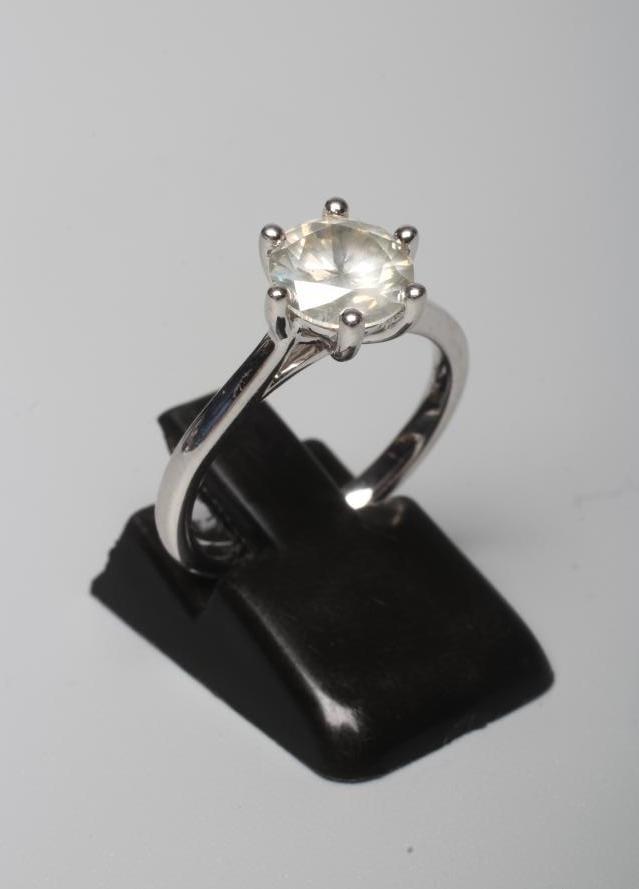 A SOLITAIRE DIAMOND RING, the round brilliant cut stone of 1.56cts claw set to a plain white shank Image