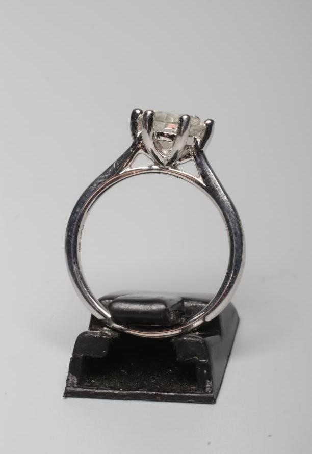 A SOLITAIRE DIAMOND RING, the round brilliant cut stone of 1.56cts claw set to a plain white shank Image