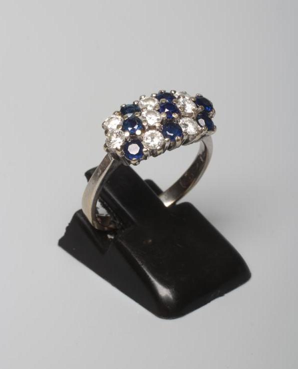 A SAPPHIRE AND DIAMOND DRESS RING, with eight each stones in diagonal settings to a plain 18ct white Image