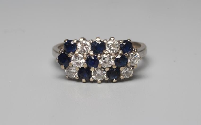 A SAPPHIRE AND DIAMOND DRESS RING, with eight each stones in diagonal settings to a plain 18ct white Image