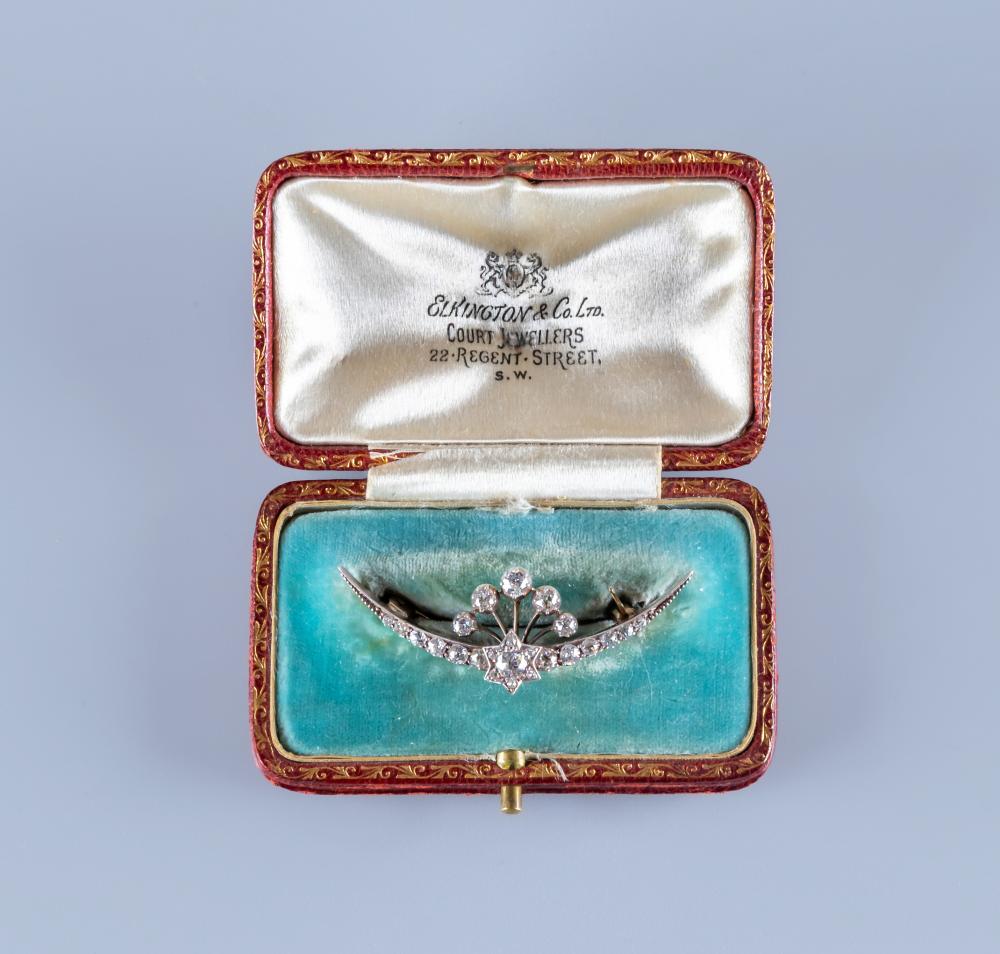 A DIAMOND CRESCENT BROOCH centred by a small star with a point set brilliant cut stone of Image