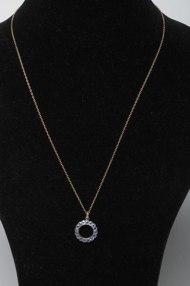 A SAPPHIRE CIRCLET PENDANT, the small facet cut stones in rub over settings to an unmarked plain Image