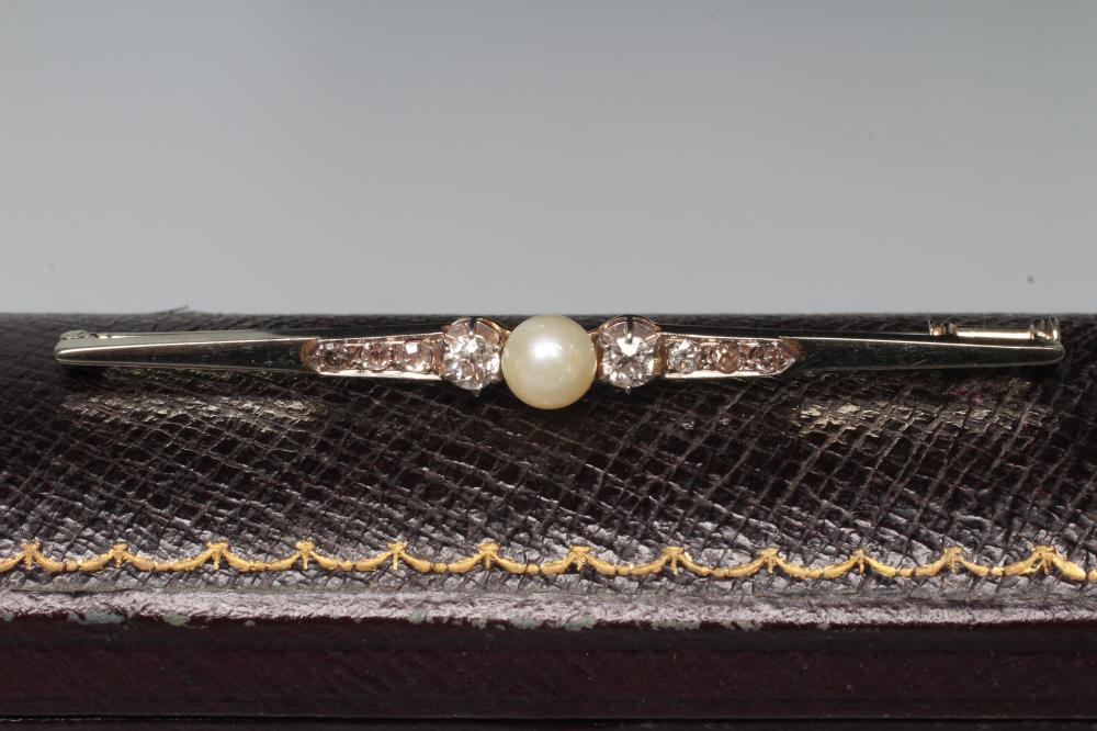 A FRENCH PEARL AND DIAMOND BAR BROOCH, the central peg set pearl flanked by two small round Image