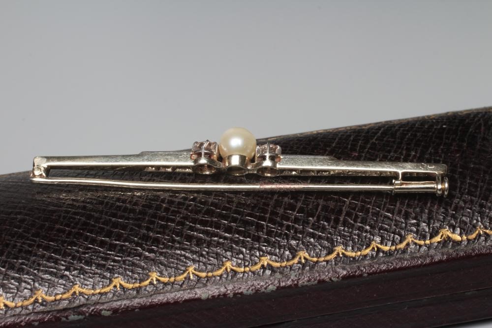 A FRENCH PEARL AND DIAMOND BAR BROOCH, the central peg set pearl flanked by two small round Image