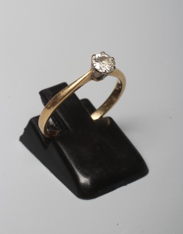 A DIAMOND SOLITAIRE RING, the brilliant cut stone of approximately 0.35cts, claw set to a plain Image