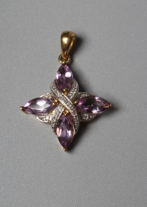 AN AMETHYST AND DIAMOND PENDANT, the four pear cut amethysts claw set to a central pave diamond set Image