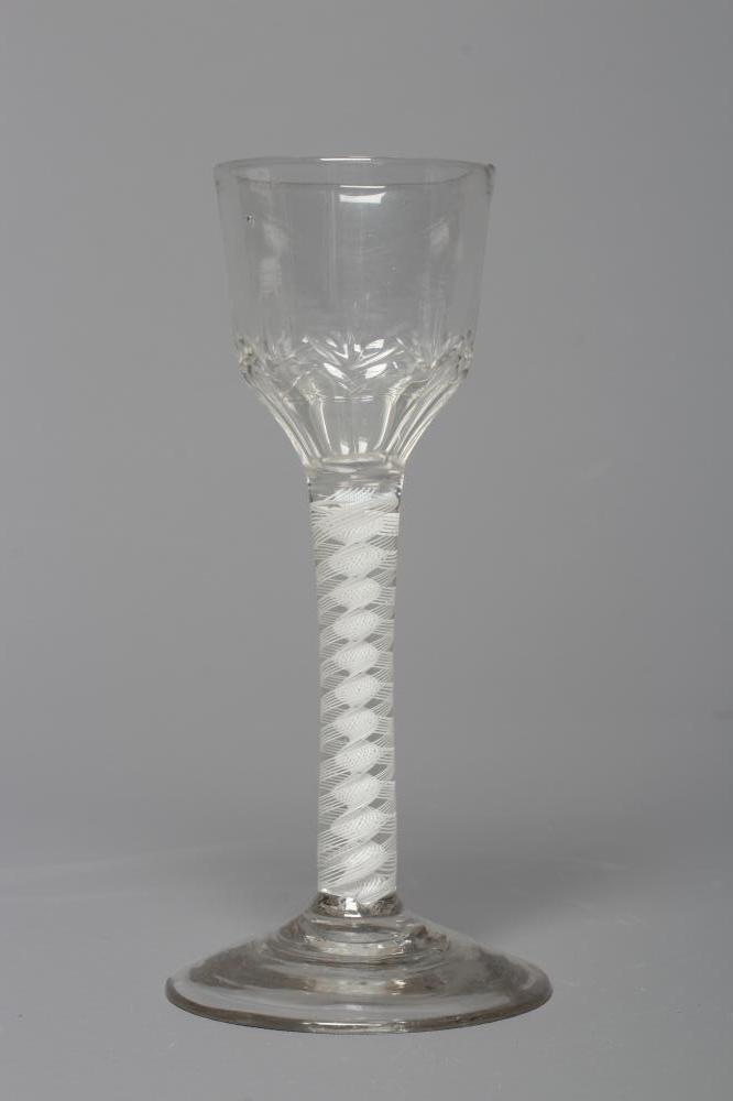 A LYNN TYPE WINE GLASS, the ogee bowl with cut panels issuing from a cylindrical stem with an opaque Image