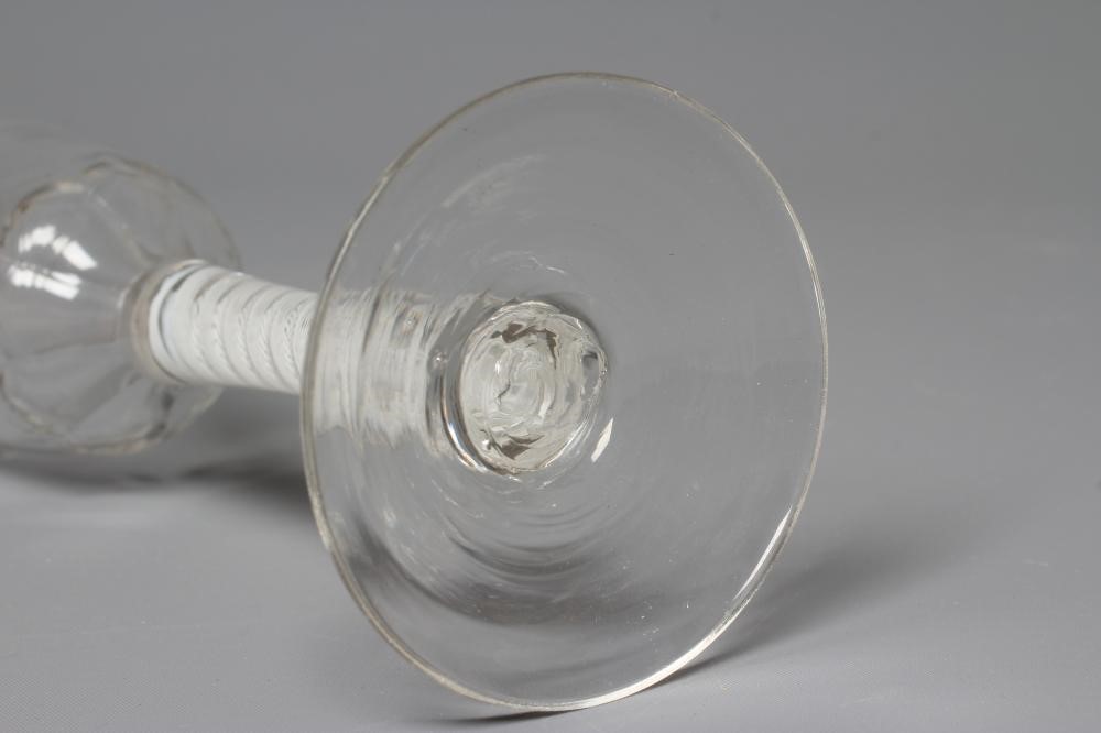 A LYNN TYPE WINE GLASS, the ogee bowl with cut panels issuing from a cylindrical stem with an opaque Image