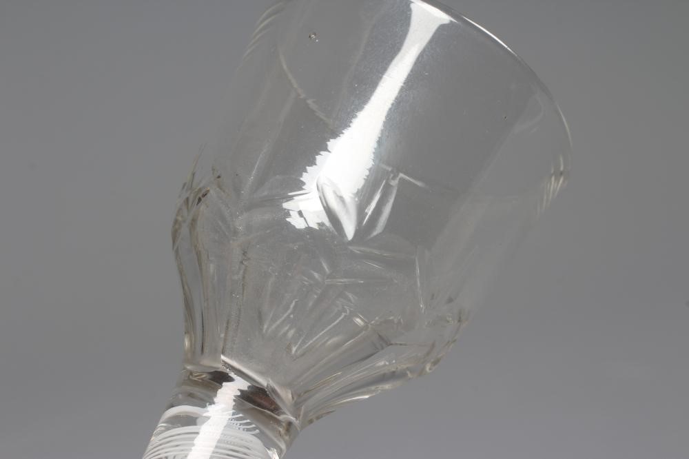 A LYNN TYPE WINE GLASS, the ogee bowl with cut panels issuing from a cylindrical stem with an opaque Image