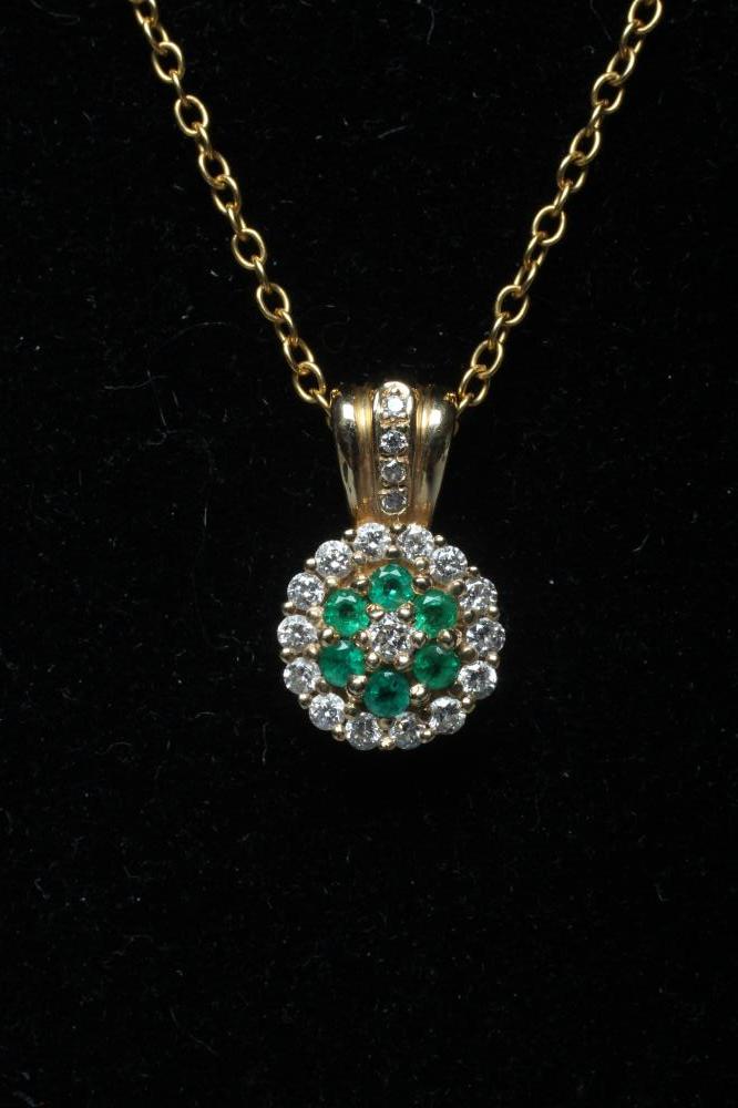 AN EMERALD AND DIAMOND CLUSTER PENDANT Image